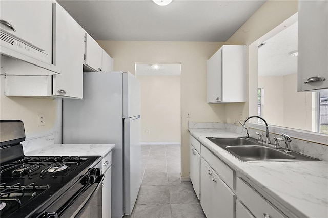 kitchen with white cabinets, black gas stove, light tile patterned floors, sink, and extractor fan