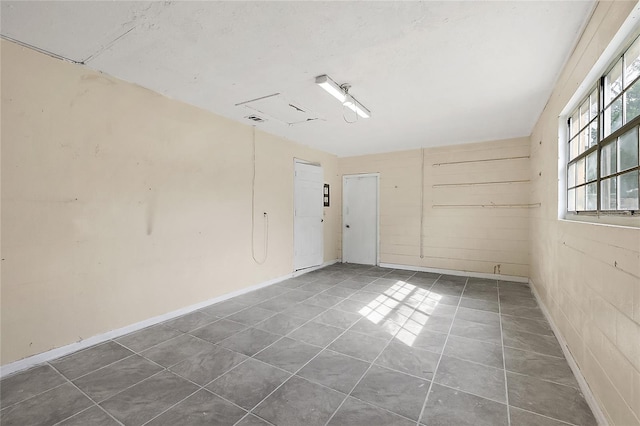 empty room featuring dark tile patterned flooring