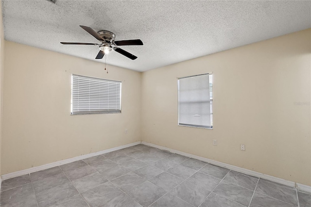 spare room featuring ceiling fan and a textured ceiling