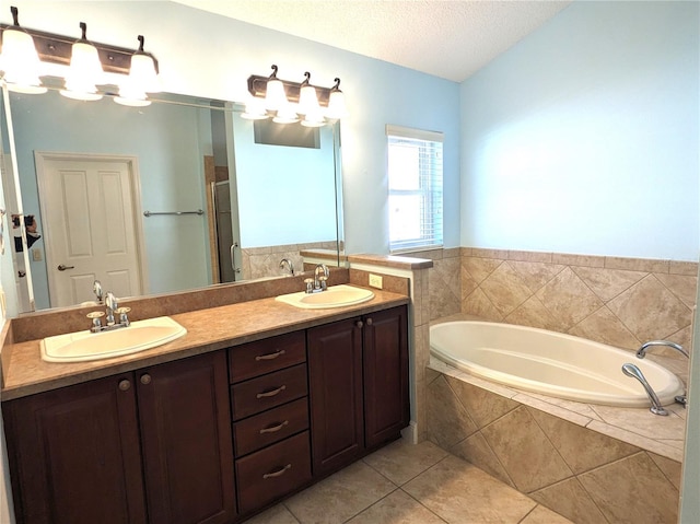 bathroom with separate shower and tub, a textured ceiling, tile patterned flooring, and vanity