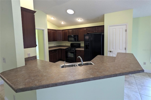 kitchen with kitchen peninsula, sink, light tile patterned floors, black appliances, and lofted ceiling