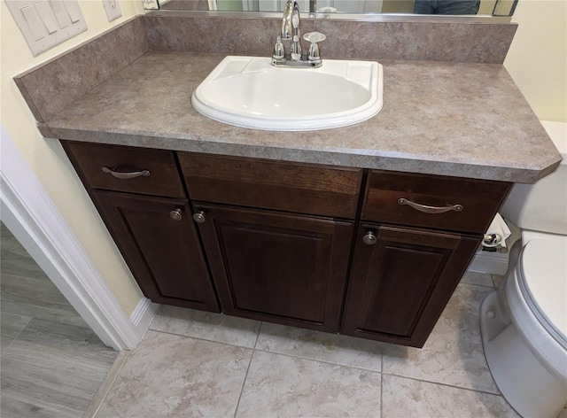 bathroom featuring vanity, toilet, and tile patterned floors