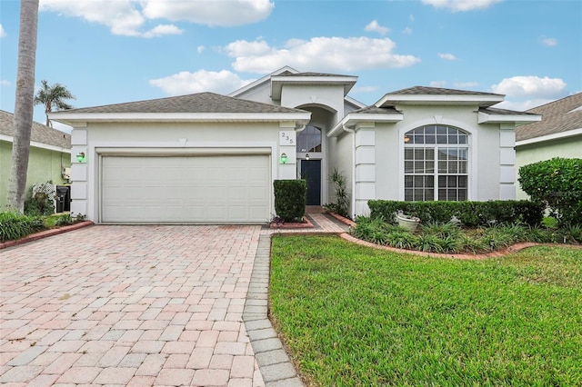 view of front of home with a garage and a front lawn