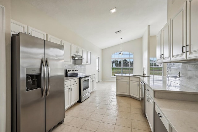 235 Royal Palm Dr, Davenport, FL 33837 - kitchen featuring appliances with stainless steel finishes, decorative backsplash, under cabinet range hood, a sink, and light tile patterned flooring