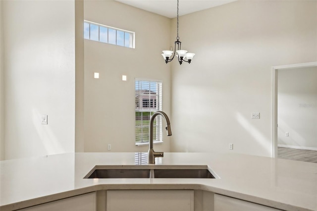 kitchen featuring hanging light fixtures, a wealth of natural light, a chandelier, and sink