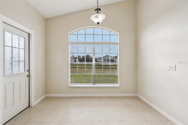 tiled foyer entrance with plenty of natural light and lofted ceiling