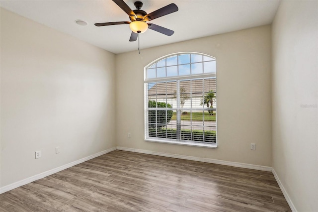 unfurnished room with wood-type flooring and ceiling fan