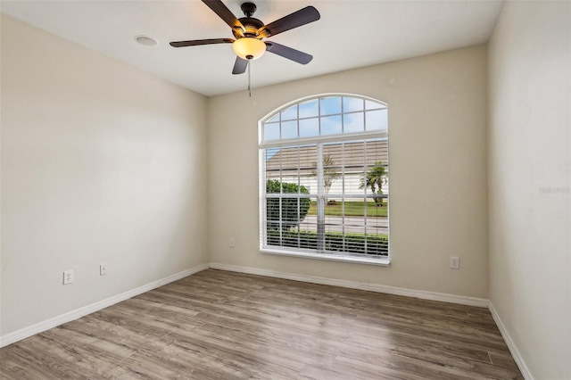235 Royal Palm Dr, Davenport, FL 33837 - empty room with wood finished floors, baseboards, and a ceiling fan
