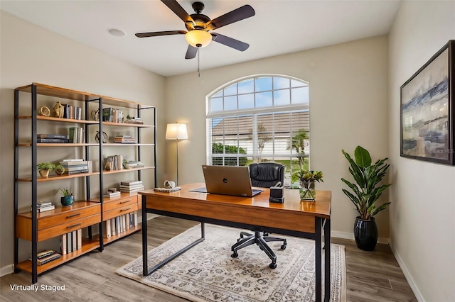 home office featuring hardwood / wood-style flooring and ceiling fan