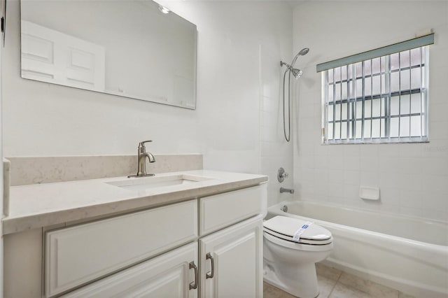 full bathroom featuring tile patterned floors, vanity, tiled shower / bath combo, and toilet