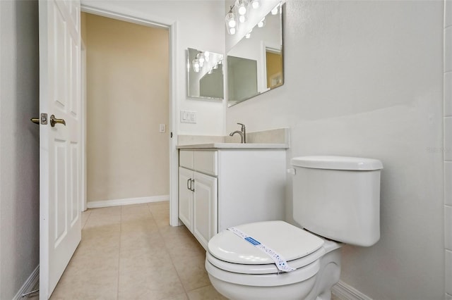 bathroom featuring vanity, tile patterned floors, and toilet