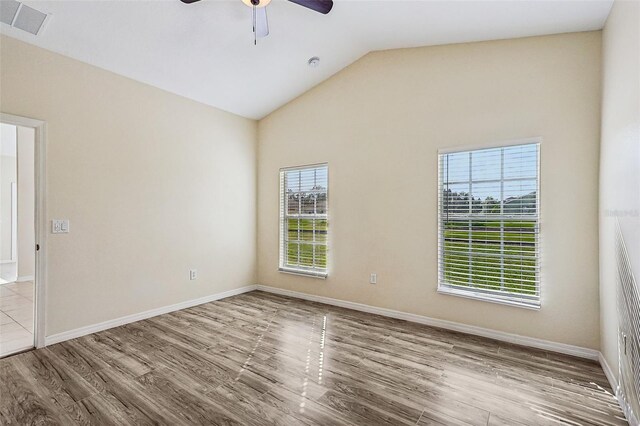 235 Royal Palm Dr, Davenport, FL 33837 - empty room with a ceiling fan, wood finished floors, lofted ceiling, and baseboards