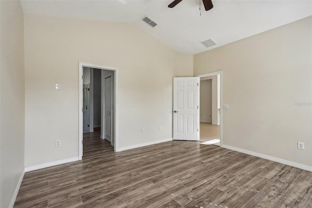 spare room featuring dark hardwood / wood-style flooring, ceiling fan, and vaulted ceiling