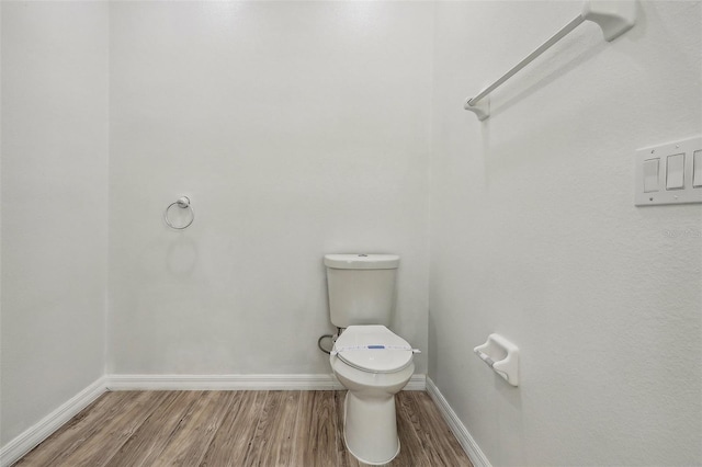 235 Royal Palm Dr, Davenport, FL 33837 - bathroom with wood finished floors, baseboards, and toilet