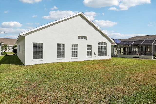 235 Royal Palm Dr, Davenport, FL 33837 - back of house featuring a lawn and stucco siding