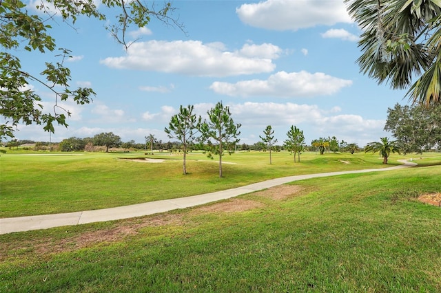 235 Royal Palm Dr, Davenport, FL 33837 - surrounding community with golf course view and a lawn