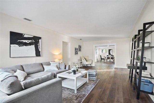 living room with dark hardwood / wood-style flooring