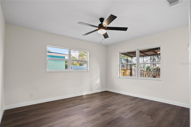 empty room featuring ceiling fan and dark wood-type flooring