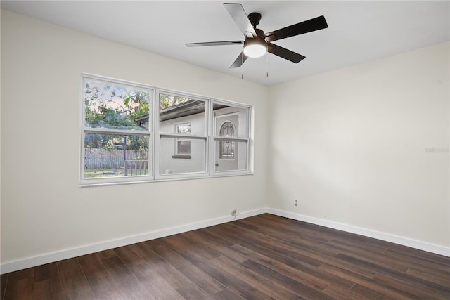 spare room with ceiling fan and dark wood-type flooring