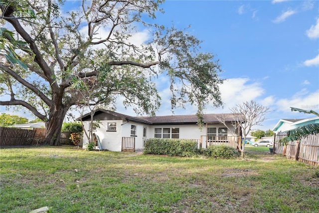 rear view of house with a yard