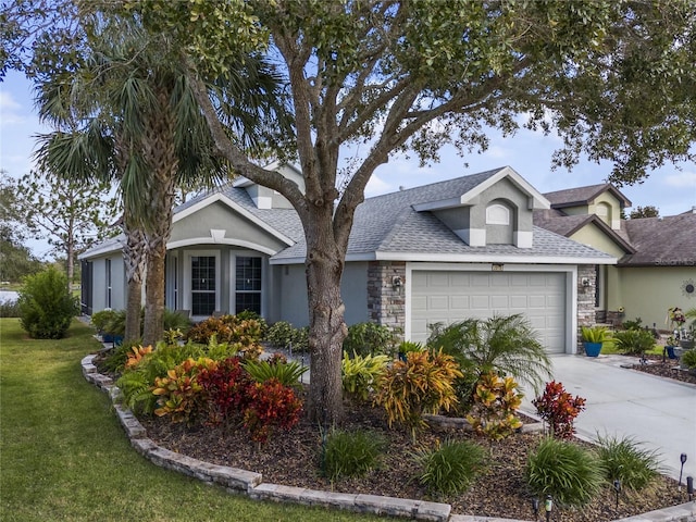 view of front of home with a front yard and a garage