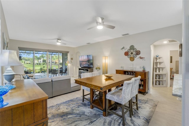 dining space with ceiling fan and light hardwood / wood-style floors