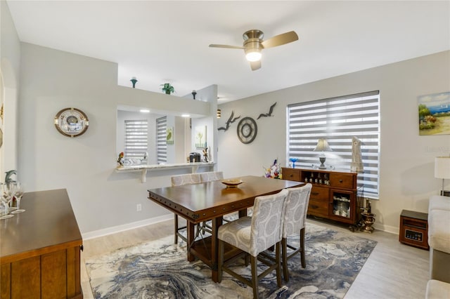 dining space with light hardwood / wood-style flooring, a wealth of natural light, and ceiling fan