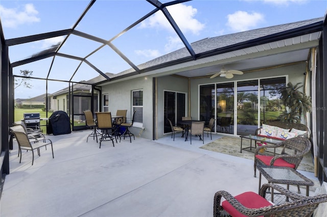 view of patio / terrace with ceiling fan, area for grilling, and glass enclosure