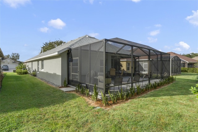 view of property exterior with glass enclosure, a patio area, and a yard