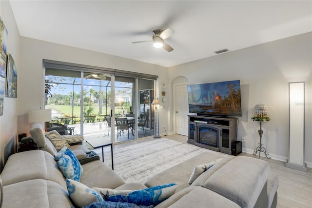 living room featuring light hardwood / wood-style floors and ceiling fan