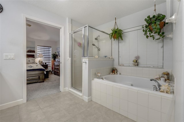 bathroom with tile patterned floors, a textured ceiling, and separate shower and tub