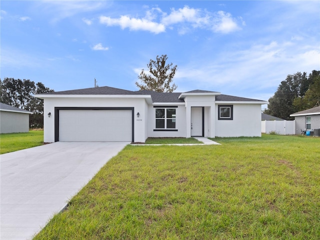 view of front of home featuring a garage and a front yard