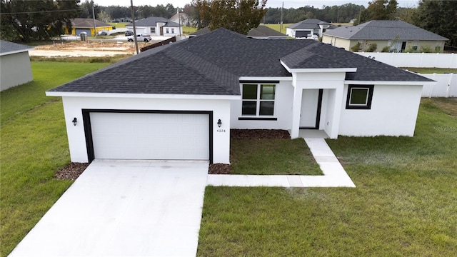 view of front of home featuring a garage and a front yard