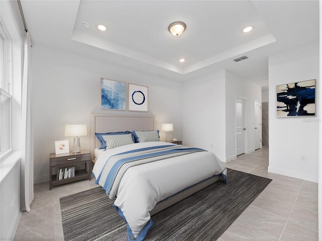 tiled bedroom with a tray ceiling