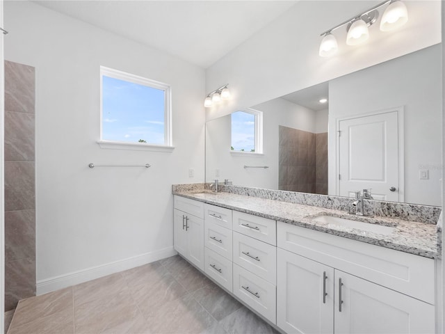 bathroom with a wealth of natural light, a shower, and vanity