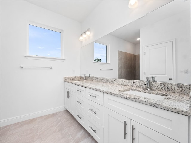 bathroom with vanity, tile patterned floors, and a shower