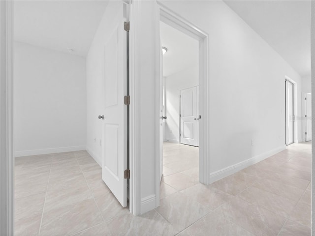 hallway with light tile patterned flooring