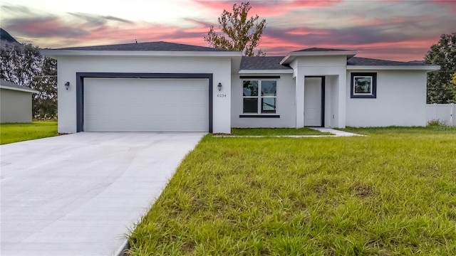 view of front facade featuring a garage and a lawn