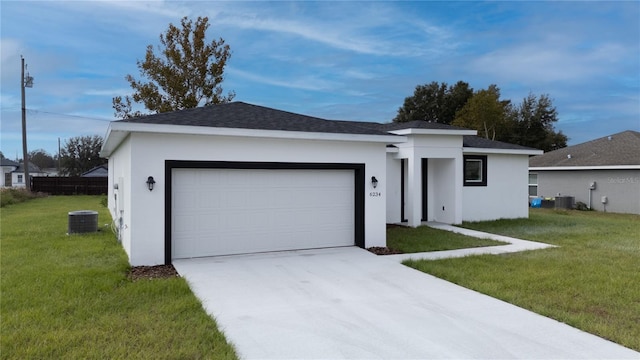 single story home featuring central AC unit, a garage, and a front yard