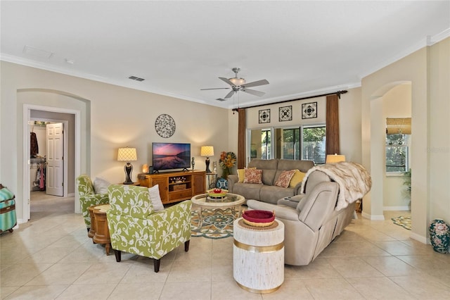 living room featuring light tile patterned flooring, ceiling fan, and ornamental molding