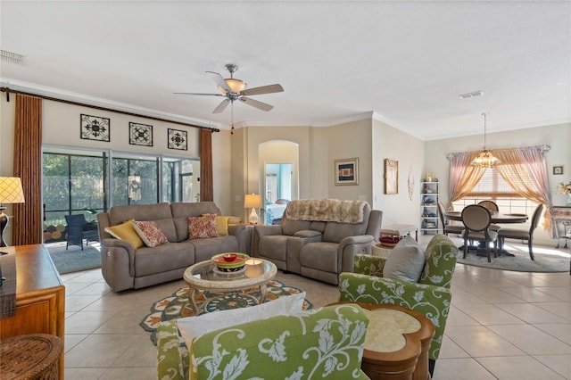 tiled living room featuring ceiling fan with notable chandelier and ornamental molding