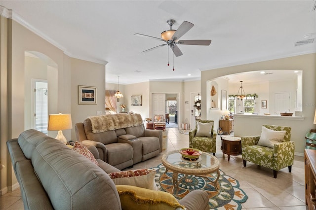 living room featuring ornamental molding, light tile patterned flooring, and ceiling fan with notable chandelier