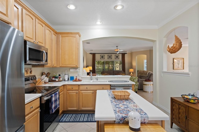 kitchen featuring stainless steel appliances, sink, ceiling fan, ornamental molding, and light brown cabinetry