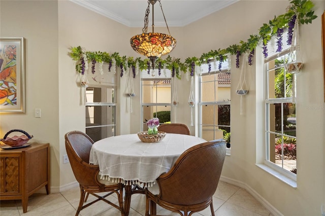 dining area with ornamental molding and light tile patterned floors