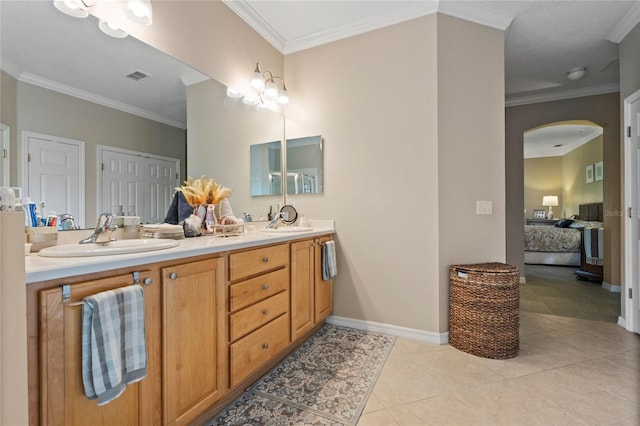 bathroom featuring crown molding, tile patterned floors, and vanity