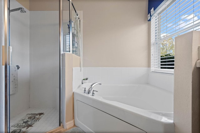 bathroom featuring shower with separate bathtub