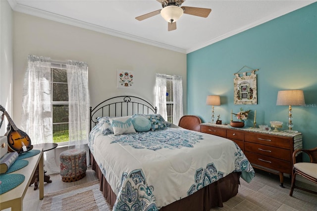 bedroom featuring ornamental molding, ceiling fan, and multiple windows