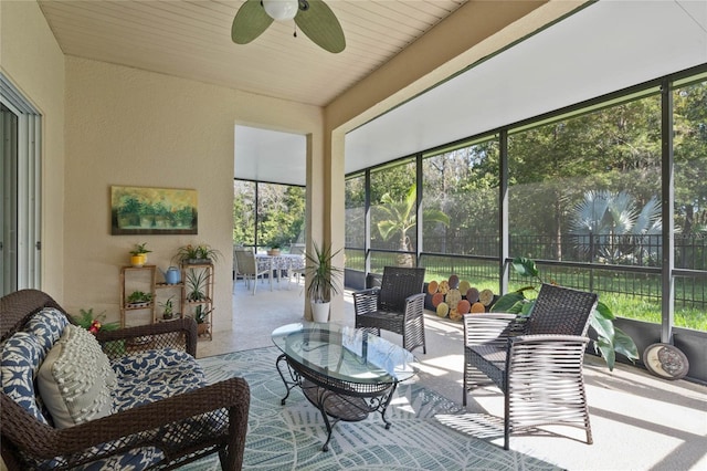 sunroom / solarium featuring ceiling fan