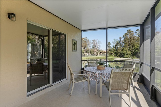 sunroom / solarium featuring a water view