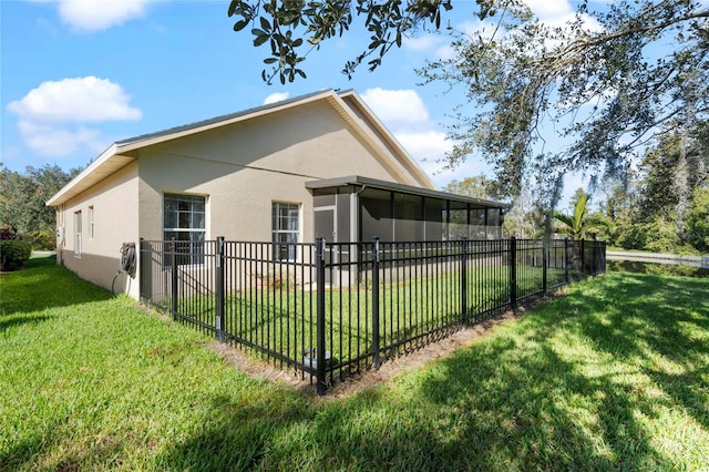 view of side of home featuring a yard and a sunroom